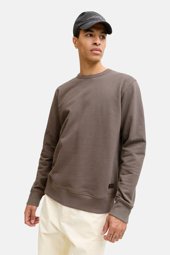 Pull marron avec col rond de PREMIUM by JACK & JONES, doté d'une subtile texture et porté avec un chapeau.