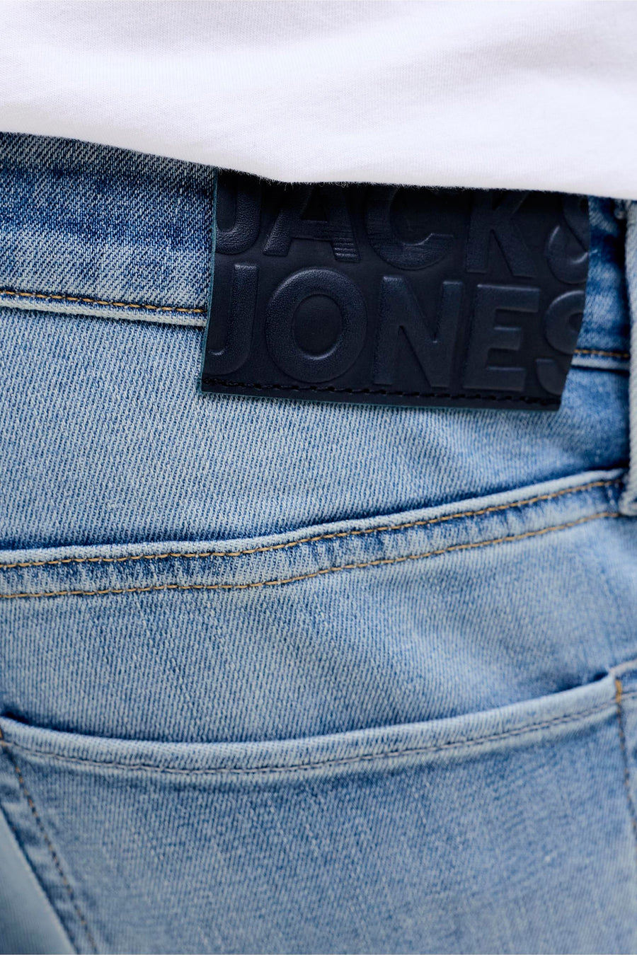 Jean slim de denim bleu clair de JACK & JONES, avec étiquette de marque et détail de poche arrière.
