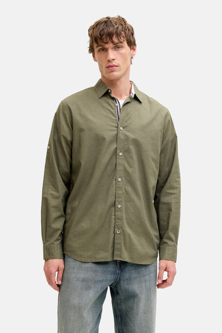 Chemise verte à manches longues de PREMIUM by JACK & JONES, portée avec un jean bleu et des chaussures en daim.