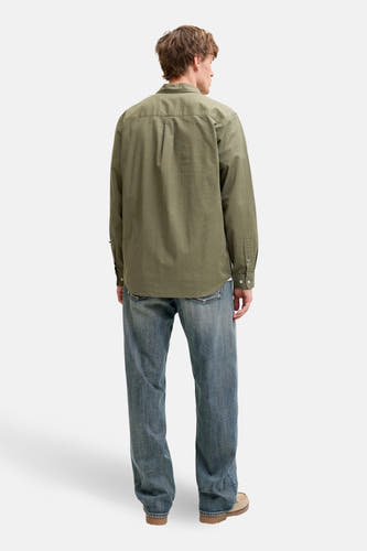 Chemise verte à manches longues de PREMIUM by JACK & JONES, vue de dos, associée à un jean bleu et des mocassins beiges.