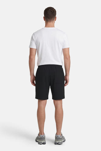 Zwarte ribbelshort van JACK & JONES JEANS INTELLIGENCE, achterkant met zak, model draagt wit T-shirt en grijze sneakers