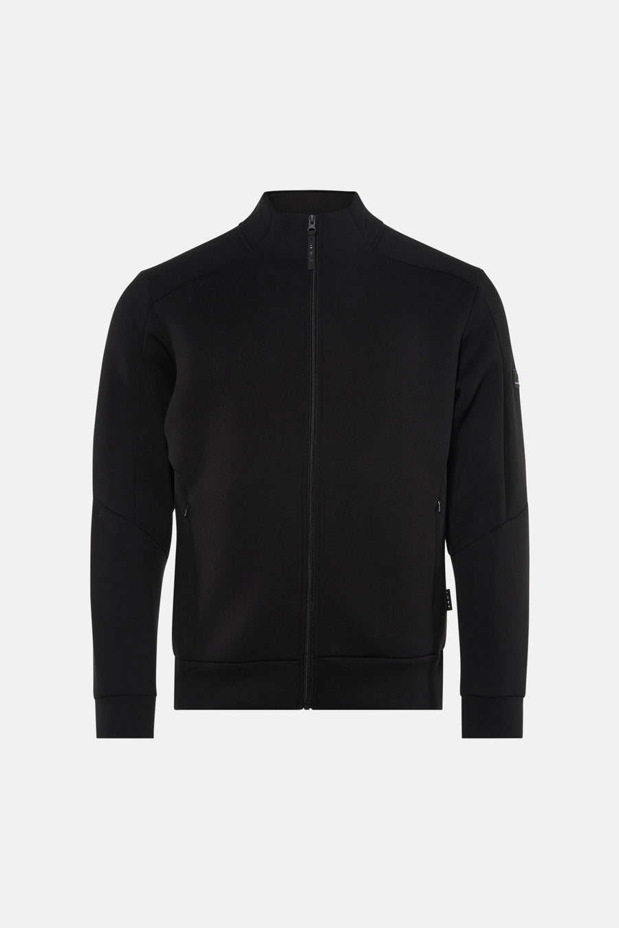 Veste courte noire de CORE BY JACK & JONES, vue de dos, avec un jean bleu et des chaussures vertes.