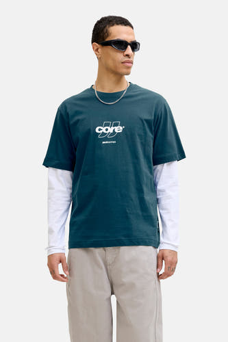 T-shirt bleu à manches courtes de CORE by JACK & JONES, porté sur un t-shirt blanc à manches longues et un collier.