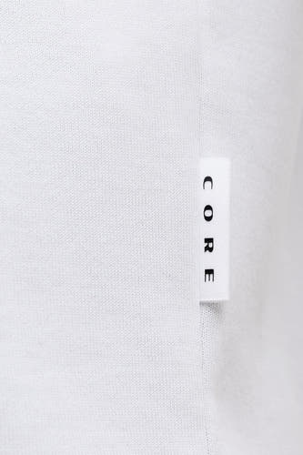 T-shirt blanc à manches courtes de CORE BY JACK & JONES, avec une étiquette portant le nom de la marque.