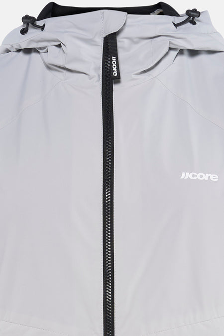 Veste courte grise de CORE BY JACK & JONES, avec fermeture éclair noire et logo sur le devant, et cordons de serrage à la capuche.