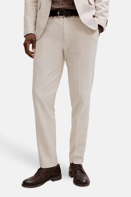 Pantalon de costume écru de PREMIUM by JACK & JONES, combiné avec une chemise marron, une ceinture noire et des chaussures en cuir marron.
