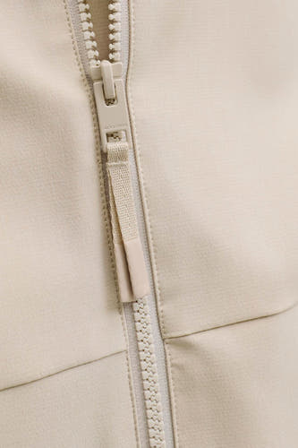 Veste courte écru de PREMIUM by JACK & JONES, avec fermeture à glissière de couleur crème.