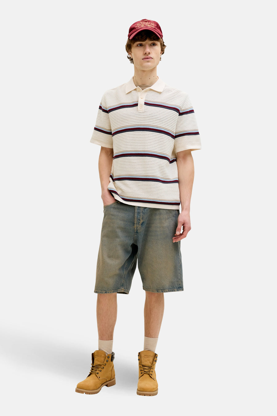 Multikleurige polo met korte mouwen van ORIGINALS BY JACK & JONES, met horizontale strepen en gedragen met denim shorts en bruine laarzen.