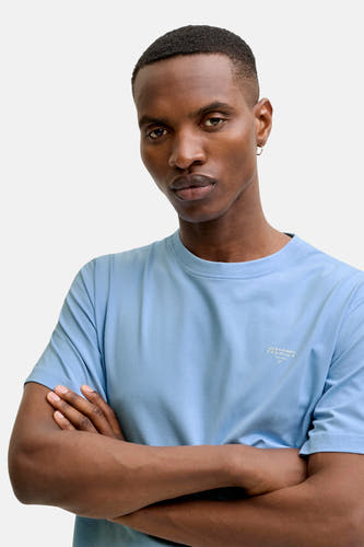 T-shirt bleu à manches courtes de PREMIUM by JACK & JONES, couleur unie avec bras croisés.