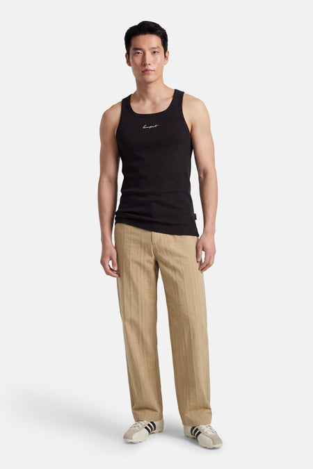 Zwarte singlet van CORE BY JACK & JONES, met wit opschrift en geribbelde textuur.