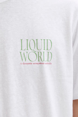T-shirt blanc de ORIGINALS BY JACK & JONES, avec imprimé texte vert et rouge sur la poitrine.