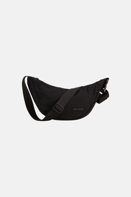 Sac à bandoulière noir d'ACCESSORIES BY JACK & JONES avec un design incurvé, une bandoulière réglable et une étiquette de marque.