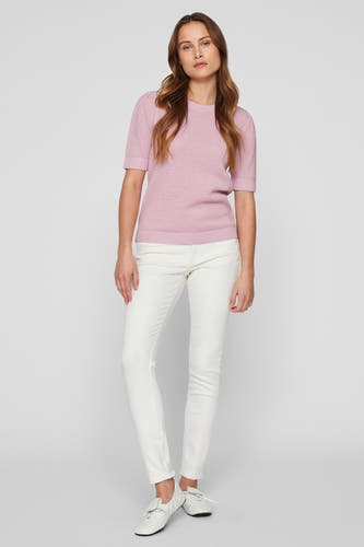 T-shirt rose de VILA, avec des manches courtes et une texture fine tr tricotée, associé à un pantalon blanc et des chaussures.