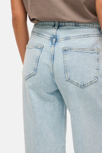 Jean en denim bleu clair large de VILA, avec des poches arrière et un aspect décontracté.