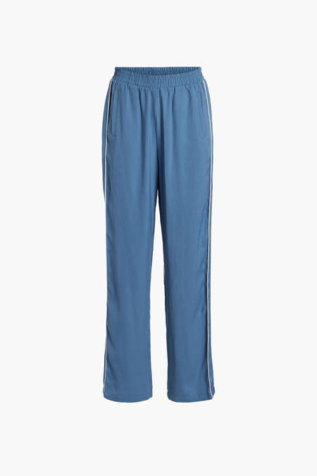 Pantalon bleu de VILA® avec une surure blanche sur les côtés, le dos visible.