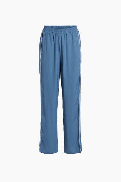 Pantalon bleu de VILA® avec une surure blanche sur les côtés, le dos visible.