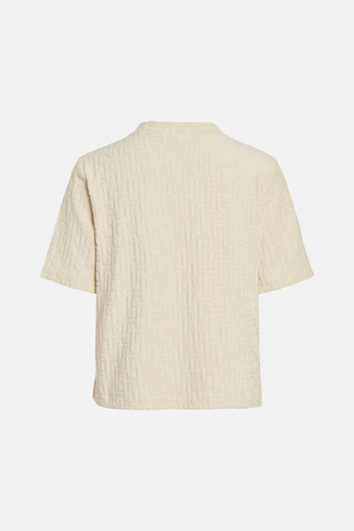 T-shirt écru à manches courtes de VILA, avec un motif géométrique et une douce texture.
