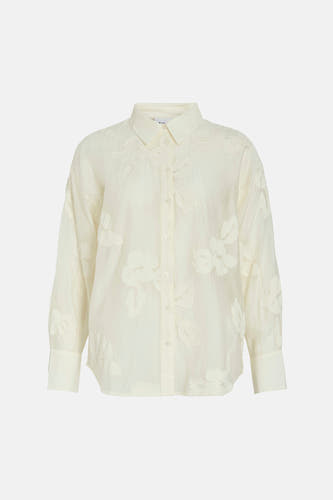 Chemise beige à manches longues de VILA, ornée de motifs floraux brodés sur l'ensemble du chemisier.