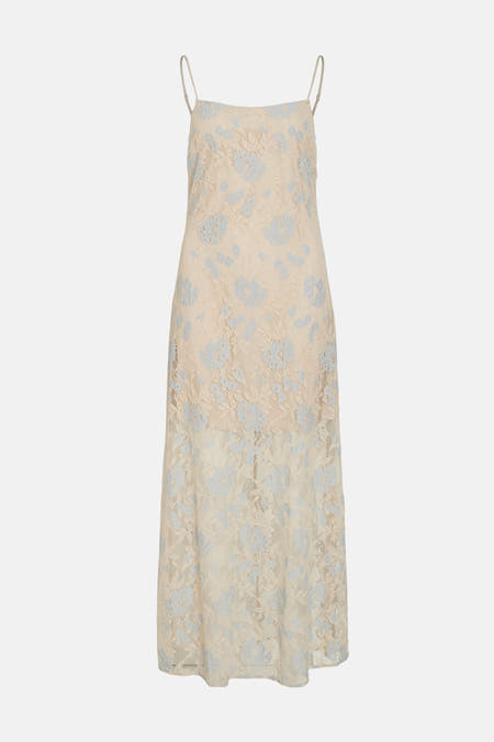 Tissu écru sans manches de VILA, avec une face à fleurs bleues claires sur un fond uni.