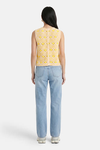 Gele gebreide gilet met geometrisch patroon van VILA®, achterkant weergegeven, gedragen met lichtblauwe jeans
