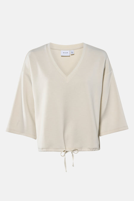 Beige shirt met V-hals en trekkoord.