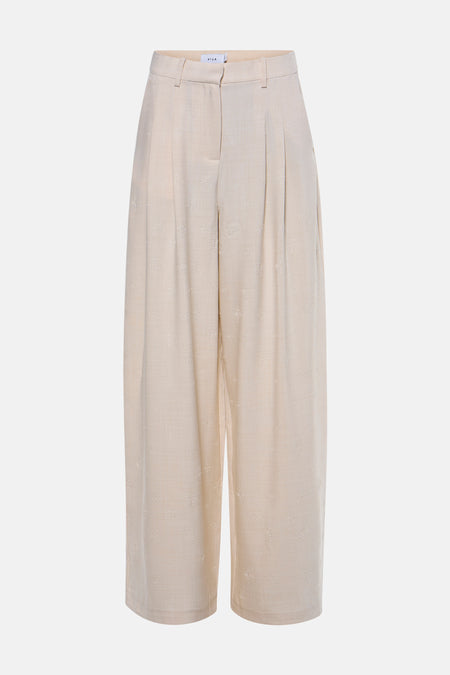 Pantalon beige de VILA® avec un motif floral subtil et des jambes larges, vu de dos.
