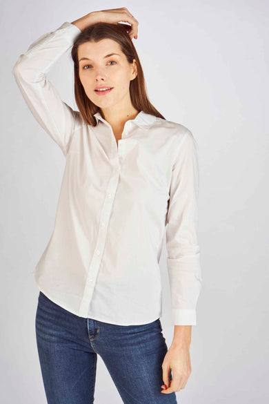 Blouse blanche de JDY, portée sous un gilet rose et associée à des jeans et des sandales.