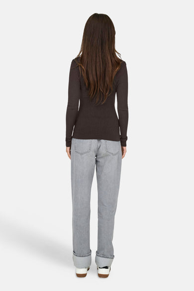 Pull marron avec col montant de ONLY®, à longues manches et texture côtelée, associé à des jeans gris.