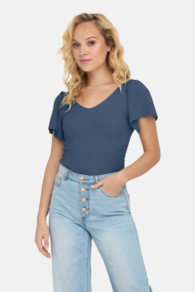 T-shirt bleu à manches courtes de ONLY®, avec structure en côtes et porté avec un jean bleu clair.