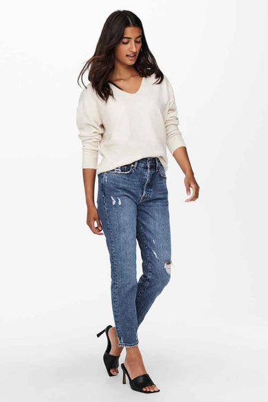 T-shirt écru avec col V d'ONLY, associé à des jeans bleus et des talons noirs.