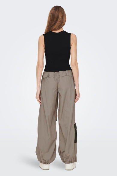 Débardeur noir ONLY, porté avec un pantalon cargo large brun et des baskets blanches.