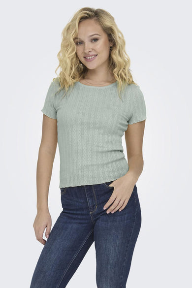 T-shirt vert de ONLY, avec des manches courtes et une fine structure en côtes, associé à un jean bleu marine.