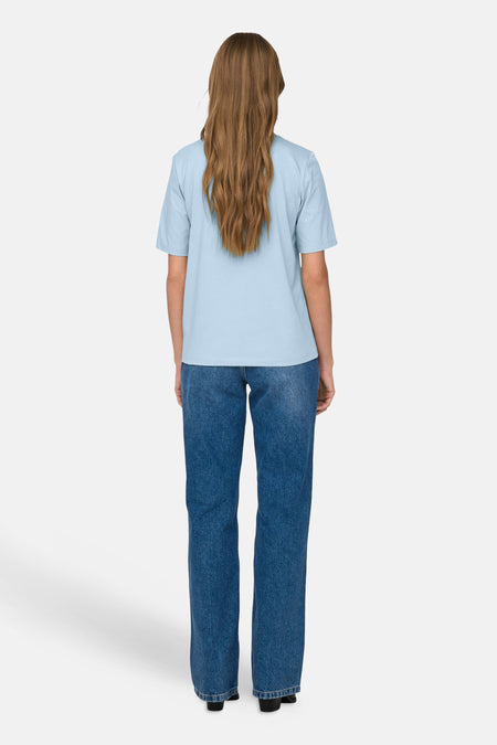 Blauw T-shirt met korte mouwen van ONLY, gezien van achteren, gecombineerd met een donkerblauwe spijkerbroek.