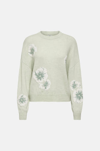 Pull vert avec col rond de JDY, orné de motifs floraux blancs.