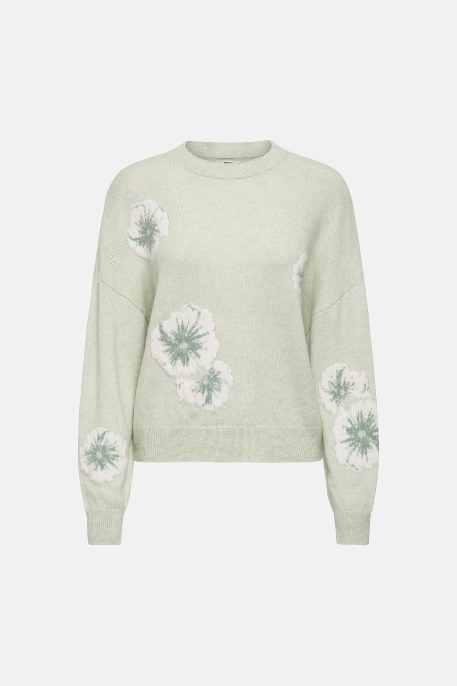 Pull vert avec col rond de JDY, orné de motifs floraux blancs.