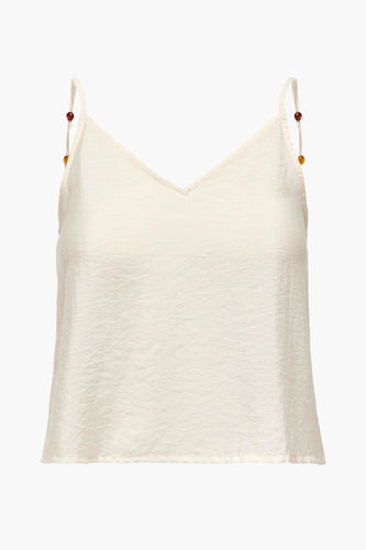 Mouwloze top in gebroken wit met kralen.