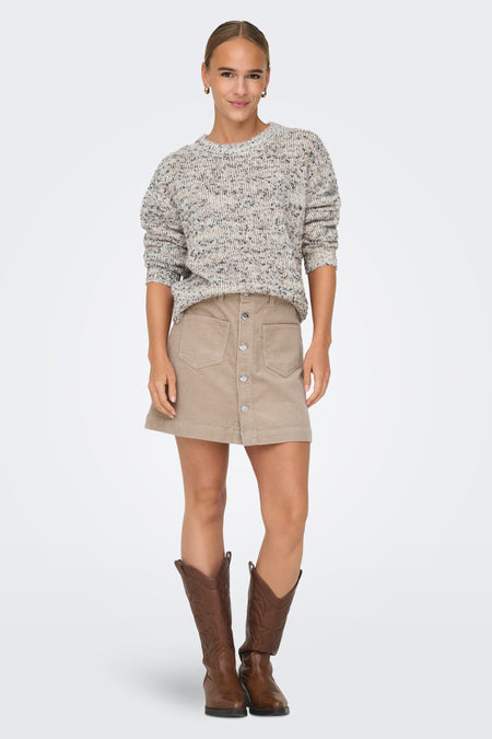Pull blanc à col rond de ONLY, avec un motif rayé et porté avec une jupe en corduroy beige et des bottes brunes.