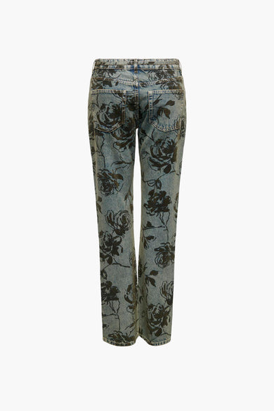 Jean droit en denim bleu moyen de ONLY®, avec un motif de fleurs noires sur toute la surface.