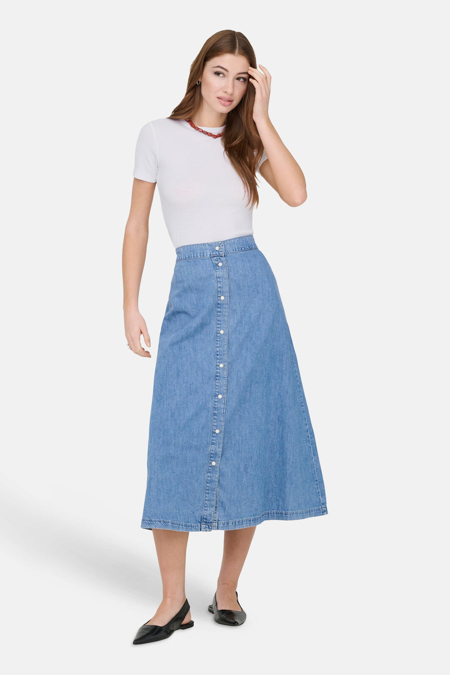 Wit T-shirt met korte mouwen van ONLY, gedragen met een denim rok met knopen en zwarte slingbacks.