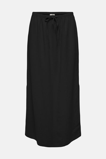 Jupe longue noire de JDY, avec fente sur le côté, combinée avec un haut blanc.