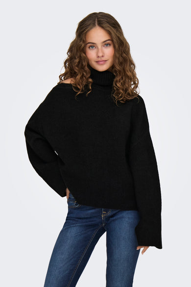 Pull à col roulé noir de JDY, coupe ample avec structure côtelée, porté avec un jean bleu, vue de face
