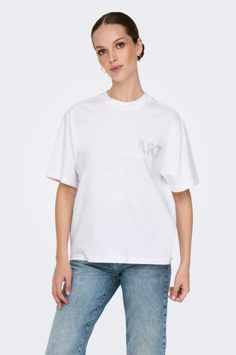T-shirt blanc à manches courtes de ONLY, avec des pierres précieuses "ART" sur la poitrine et associé à un jean.
