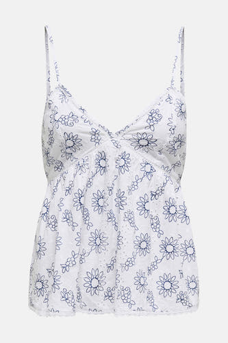 Blouse sans manches blanche de ONLY, avec imprimé de fleurs bleues et détails en dentelle.