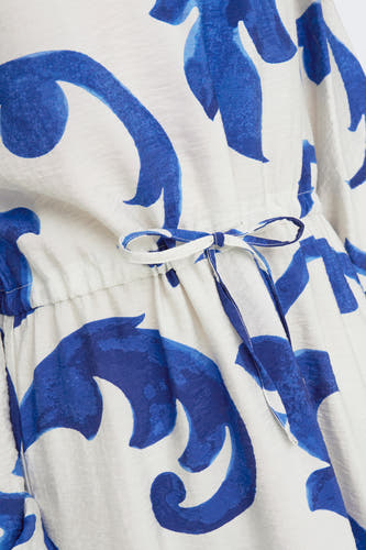 Tunique bleue à longues manches de JDY, avec un motif blanc et bleu et une ceinture élastiquée.