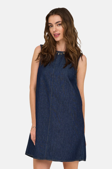 Robe de denim bleu marine de JDY, avec une chaîne d'or et un bracelet d'or.