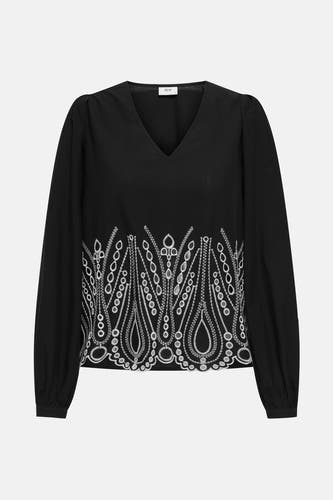 Blouse noire à manches longues de JDY, avec des manches bouffantes et des détails de boutons sur les poignets.