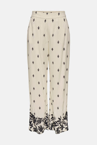 Pantalon écru de JDY, avec un motif de feuilles et une bordure de fleurs en bas.