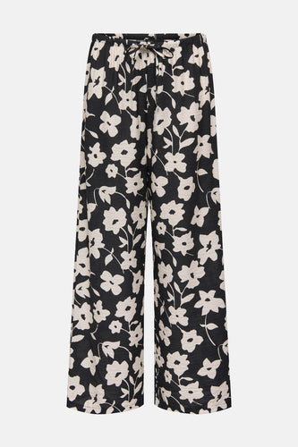 Zwarte bloemenbroek met wijde pijpen en trekkoord.