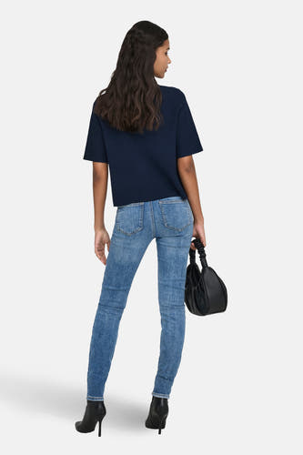Gilet bleu de JDY, vu de dos, combiné avec un jean et des bottes noires.