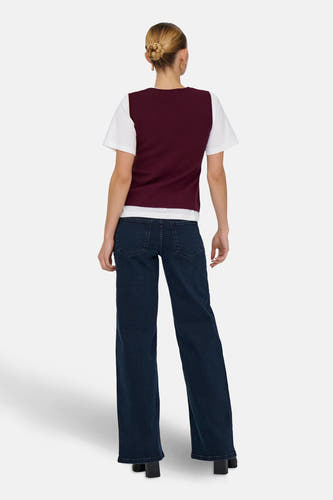 T-shirt bordeaux de JDY, porté sur un T-shirt blanc et associé à des jeans bleus foncés larges.